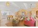 Bright living room featuring wood paneling, a foosball table, and eclectic decor for a playful and stylish space at 8501 Midnight Pass Rd, Sarasota, FL 34242