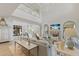 Elegant living room featuring high ceilings, fireplace, refined decor, and abundant natural light at 8501 Midnight Pass Rd, Sarasota, FL 34242