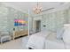Charming main bedroom with decorative wallpaper, chandelier, and a waterfront view at 8501 Midnight Pass Rd, Sarasota, FL 34242