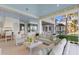 Elegant outdoor living space with comfortable seating and views of the pool at 8501 Midnight Pass Rd, Sarasota, FL 34242