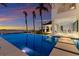 Gorgeous pool area featuring palm trees, waterfront views, and outdoor dining at 8501 Midnight Pass Rd, Sarasota, FL 34242