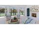 Elegant pool house interior with comfortable seating, a cozy fireplace, and charming tennis racket decor at 8501 Midnight Pass Rd, Sarasota, FL 34242