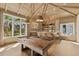 Recreation room featuring a pool table, custom bar with seating, and ample natural light at 8501 Midnight Pass Rd, Sarasota, FL 34242