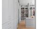 Spacious walk-in closet with custom shelving and ample storage space, designed for organization and style at 8501 Midnight Pass Rd, Sarasota, FL 34242