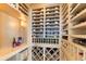 A custom wine cellar featuring extensive shelving, elegant lighting, and ample storage for various wine collections at 8501 Midnight Pass Rd, Sarasota, FL 34242