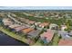 Expansive aerial view of a community featuring lush landscaping, tranquil lakes, and meticulously maintained properties at 15608 Leven Links Pl, Lakewood Ranch, FL 34202