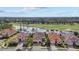 Stunning aerial view of homes on a waterfront property adjacent to lush golf course at 15608 Leven Links Pl, Lakewood Ranch, FL 34202