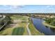 Breathtaking aerial shot showcasing a golf course, tranquil lake, and luxurious homes in a beautiful community at 15608 Leven Links Pl, Lakewood Ranch, FL 34202