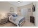 Bedroom featuring wooden bed frame, side table and neutral walls at 15608 Leven Links Pl, Lakewood Ranch, FL 34202