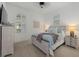Bright bedroom with light blue bedding, white furniture, and plantation shutters at 15608 Leven Links Pl, Lakewood Ranch, FL 34202