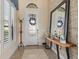 Inviting foyer with decorative glass door, stylish mirror, and ample natural light at 15608 Leven Links Pl, Lakewood Ranch, FL 34202