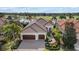 Gorgeous home with paver driveway, lush landscaping, and a tile roof at 15608 Leven Links Pl, Lakewood Ranch, FL 34202