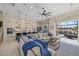 Open floor plan with a large sectional, island kitchen, and sliding doors to the lanai at 15608 Leven Links Pl, Lakewood Ranch, FL 34202