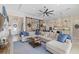 Spacious living area with hardwood floors, barn doors, and a cozy sectional sofa at 15608 Leven Links Pl, Lakewood Ranch, FL 34202