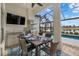 Elegant outdoor kitchen with grill, granite countertops, and dining area by the pool at 15608 Leven Links Pl, Lakewood Ranch, FL 34202
