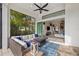 A luxurious outdoor seating area with fire pit seamlessly transitions to the interior through sliding glass doors at 15608 Leven Links Pl, Lakewood Ranch, FL 34202