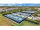 Aerial view of multiple well-maintained community pickleball courts with seating and shade at 15608 Leven Links Pl, Lakewood Ranch, FL 34202