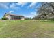 Expansive backyard with lush lawn and mature trees providing a private and serene setting at 1817 Curry Ave # 57, Nokomis, FL 34275