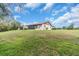 Expansive backyard with lush green grass and mature trees provides a canvas for outdoor enjoyment at 1817 Curry Ave # 57, Nokomis, FL 34275