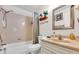 Cozy bathroom with a shower-tub combo, single sink vanity, and decorative 'Sun, Sand & Serenity' sign at 1817 Curry Ave # 57, Nokomis, FL 34275