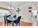 Bright dining room featuring a chandelier, wood floors, and natural light from a window at 1817 Curry Ave # 57, Nokomis, FL 34275