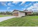 Exterior of home featuring an attached garage, manicured lawn and beautiful landscaping at 1817 Curry Ave # 57, Nokomis, FL 34275