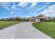 Exterior of home featuring a long driveway leading to a garage, surrounded by lush green lawn at 1817 Curry Ave # 57, Nokomis, FL 34275