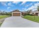 Inviting single-story home with a long driveway leading to a spacious two-car garage at 1817 Curry Ave # 57, Nokomis, FL 34275
