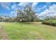 Expansive front yard with mature trees and well-maintained lawn, creating a picturesque setting at 1817 Curry Ave # 57, Nokomis, FL 34275