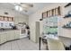 Well-lit kitchen with tile floors, a ceiling fan and an adjacent eat-in area with lots of cabinets at 1817 Curry Ave # 57, Nokomis, FL 34275