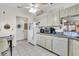 Spacious kitchen featuring white appliances and white cabinetry with breakfast nook at 1817 Curry Ave # 57, Nokomis, FL 34275
