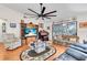 Comfortable living room featuring a large ceiling fan, wood floors, and sliding door to the lanai at 1817 Curry Ave # 57, Nokomis, FL 34275