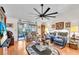 Cozy living room boasts hardwood floors, a ceiling fan, and sliding glass doors to the patio at 1817 Curry Ave # 57, Nokomis, FL 34275