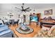 Spacious living room featuring wood floors, a ceiling fan, and views into the dining room and kitchen at 1817 Curry Ave # 57, Nokomis, FL 34275