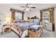 Comfortable main bedroom featuring natural light, neutral carpeting, and matching furniture at 1817 Curry Ave # 57, Nokomis, FL 34275