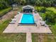 Aerial view of community pool with lounge chairs and umbrellas at 1817 Curry Ave # 57, Nokomis, FL 34275