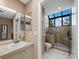 Bright bathroom with sink, shower and toilet. Skylight over shower provides natural light at 1922 Harbourside Dr # 1102, Longboat Key, FL 34228