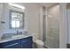 Modern bathroom featuring a stylish vanity, decorative mirror, and a glass-enclosed shower with decorative accent tile at 262 Island Cir, Sarasota, FL 34242