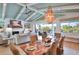 Elegant dining room with shell chandelier, fireplace, and backyard views perfect for hosting dinner parties at 262 Island Cir, Sarasota, FL 34242