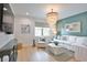 Living room features shiplap accent wall, light wood floors, elegant lighting and comfortable seating at 262 Island Cir, Sarasota, FL 34242