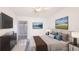 Stylish bedroom featuring modern decor, mounted TV, and ambient lighting for relaxation at 2782 Woodgate Ln # 18, Sarasota, FL 34231