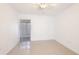 Bright, minimalist bedroom with tiled floor and sliding doors, creating a serene space at 2782 Woodgate Ln # 18, Sarasota, FL 34231