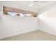 Bright bedroom features tile floors, neutral wall paint, and horizontal window at 2782 Woodgate Ln # 18, Sarasota, FL 34231