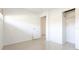 Clean bedroom with tile flooring and open closet providing ample storage at 2782 Woodgate Ln # 18, Sarasota, FL 34231