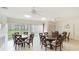 Clubhouse room featuring tables, chairs, tile floors, and sliding doors at 2782 Woodgate Ln # 18, Sarasota, FL 34231