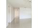 Hallway with white walls and tiled flooring at 2782 Woodgate Ln # 18, Sarasota, FL 34231