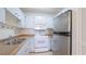 Well-maintained kitchen with white cabinets, modern appliances, and laminate countertops at 2782 Woodgate Ln # 18, Sarasota, FL 34231
