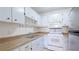 Functional kitchen featuring white cabinets, essential appliances, and laminate countertops at 2782 Woodgate Ln # 18, Sarasota, FL 34231