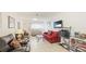 Inviting living room with tile flooring, comfortable seating, and entertainment center at 2782 Woodgate Ln # 18, Sarasota, FL 34231