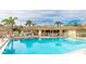 Community swimming pool featuring clear blue water and plenty of seating at 2782 Woodgate Ln # 18, Sarasota, FL 34231